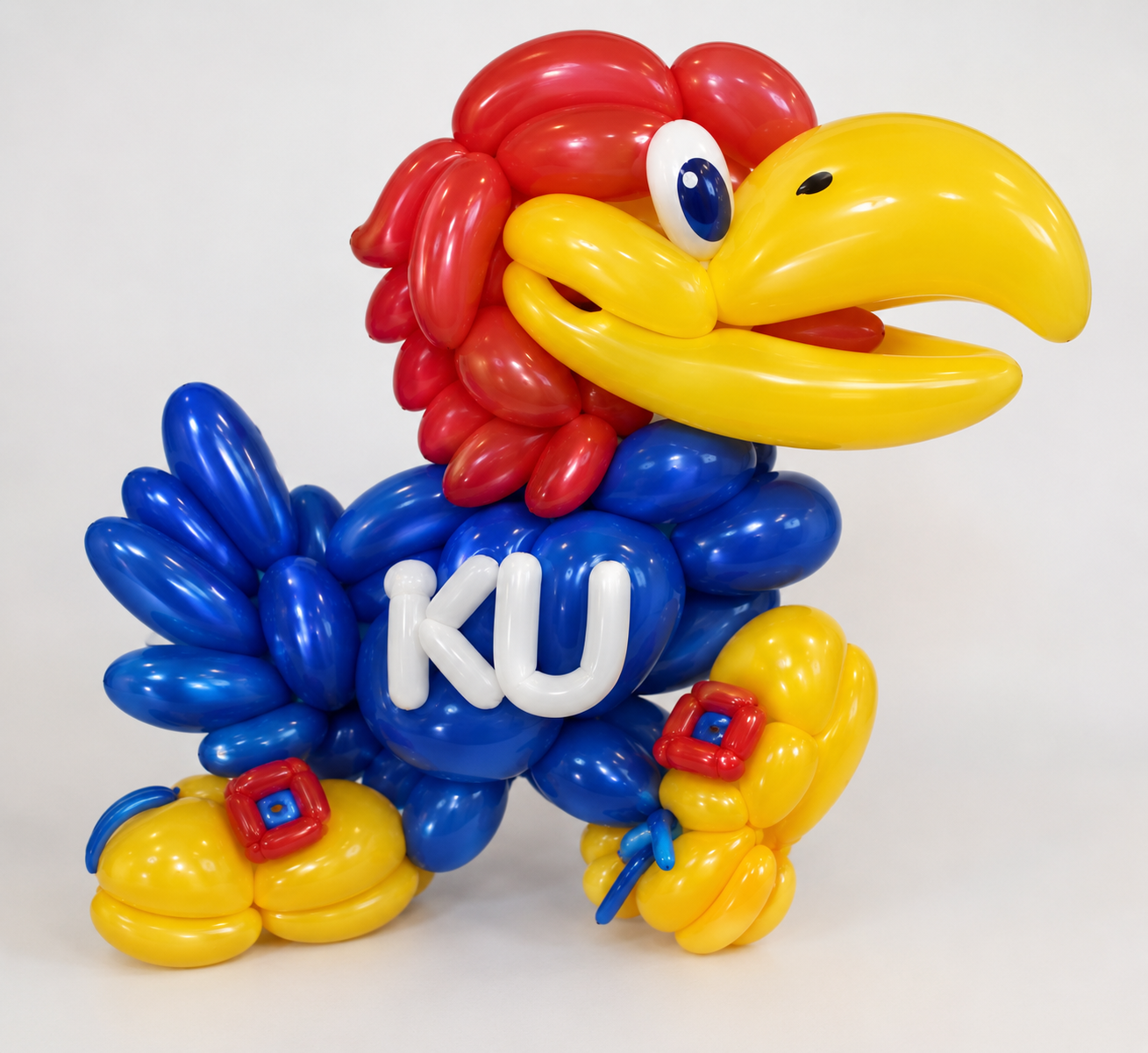 Balloon art sculpture of the KU Jayhawk in red, blue and yellow balloons